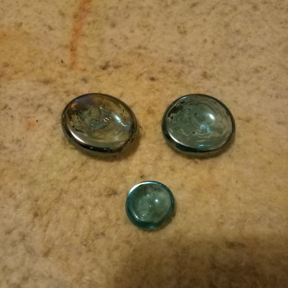3 aqua-like colored checkers pieces 2 big 1 small
